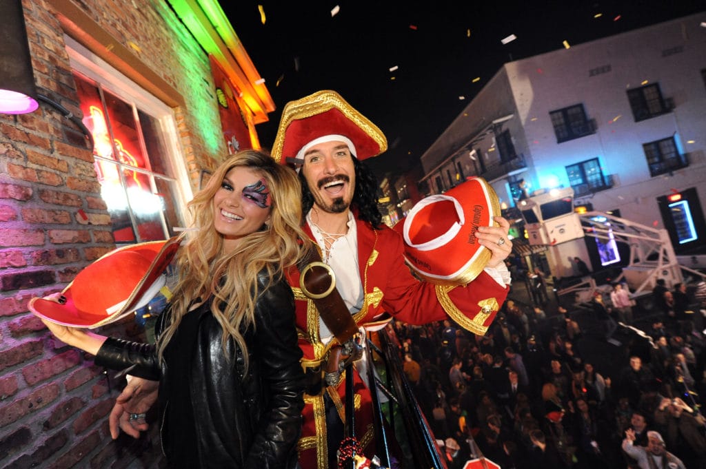 Captain Morgan and his First Mate Supermodel Marisa Miller throw beads from the balcony of Bourbon Street Blues Co. during Mardi Gras in New Orleans, Sunday, March 6, 2011. The pair were in town as part of the Captain's One Million Poses campaign.