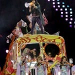 Russell Brand sings Pure Imagination and I Am the Walrus aboard a psychedelic yellow tour bus;
