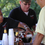 Caterer from Lady Fingers of Louisville pour Four Roses Bourbon for guests after the conversation at Let's Talk Bourbon