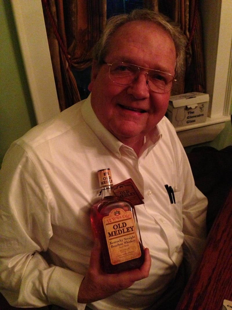 Charles Medley holds a bottle of Old Medley Bourbon