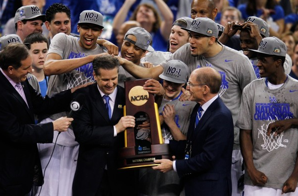 Kentucky head coach John Calipari and Kentucky President Eli Capilouto hold the trophy after the Wildcats defeat the Kansas Jayhawks, 67-59, in the national championship game.
