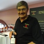 Four Roses_Brand Ambassador Al Young holds a bottle OBSK, one of the Ten Unique Recipes of Four Roses Bourbon, all ten were sampled for the first time ever at Tales of the Cocktail 2011