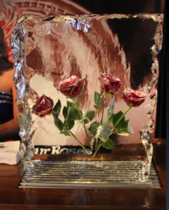 4 frozen roses in a block of ice that appear the same as they did in a vintage Four Roses advertisement that won many awards