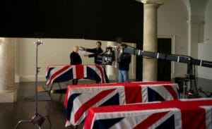 Judi Dench as in M in Skyfall stands behind the coffins of British Soldiers with flags draped in Union Jack Flags. This Bond is Judi Dench's last role as M