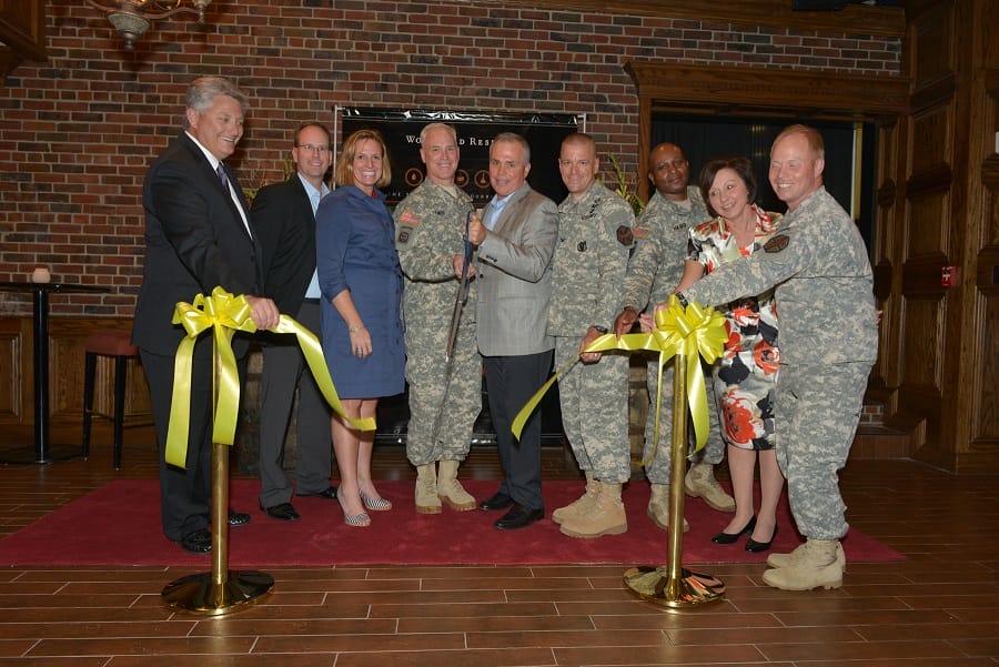 Maj. Gen. Jeff Smith, commander of U.S. Cadet Command and Ft. Knox, cuts the ceremonial ribbon with Joe Bollinger, director of military and transportation for Brown-Forman, to commenorate the grand opening of the Woodford Reserve Room at the Saber and Quill Club on May 15 at Ft. Knox.